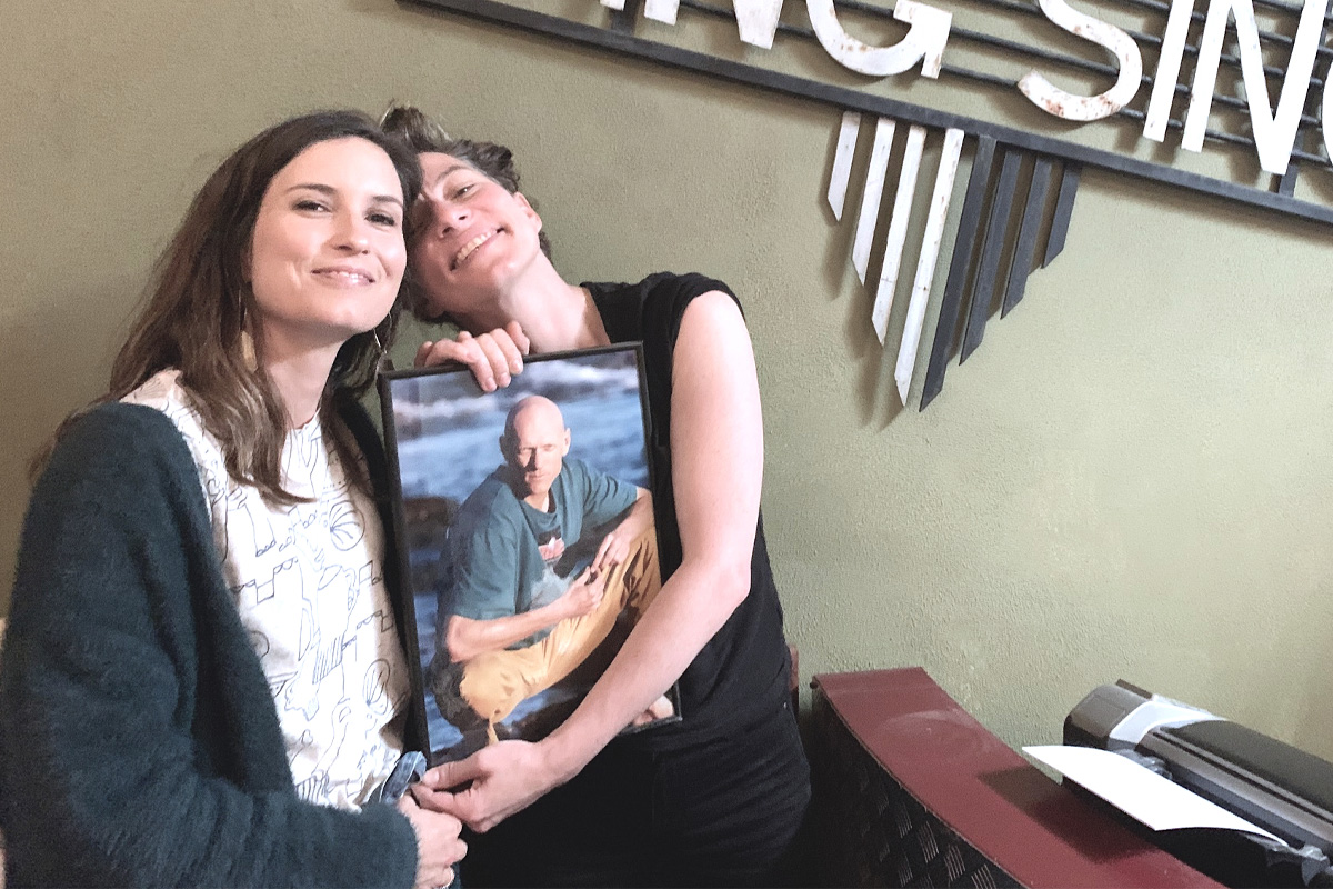 Image of Missy Higgins and Amanda Palmer, holding an image of Midnight Oil's Peter Garrett
