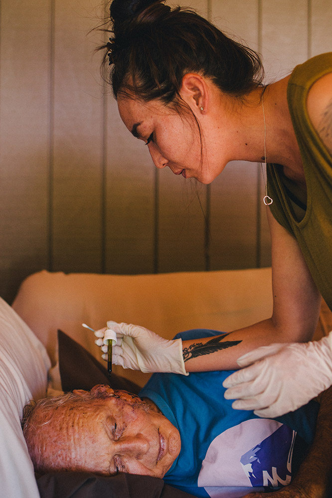 A man with a facial tumour receiving treatment